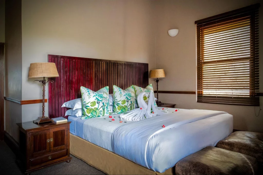 Luxury king suite at Baines River Camp with towel art and flower petals