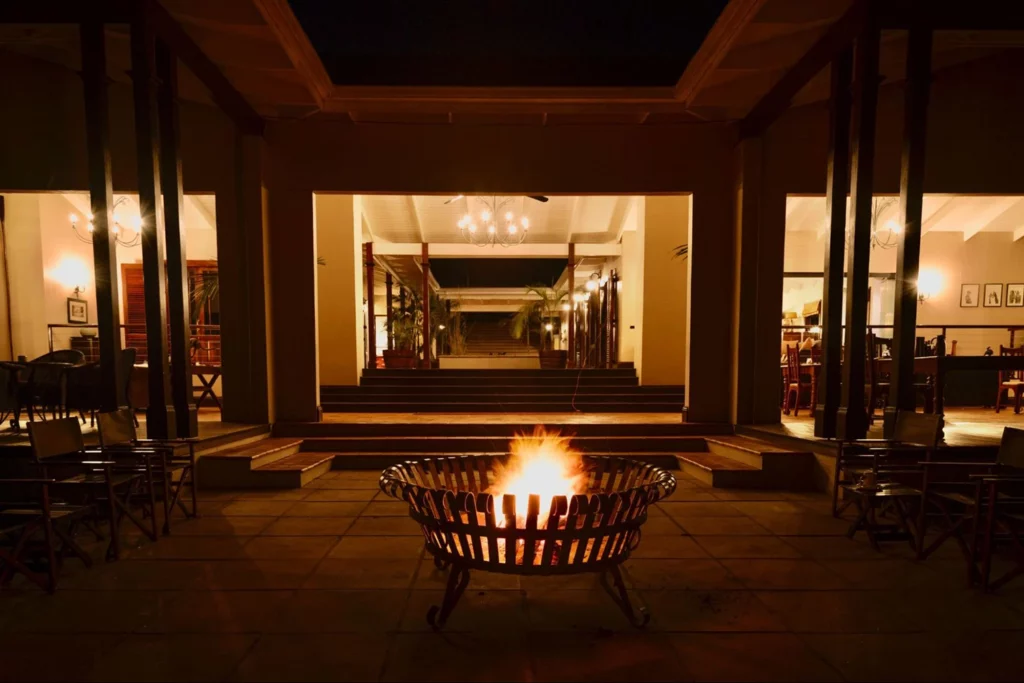 Main lodge lounge and fire pit at Baines River Camp at dusk