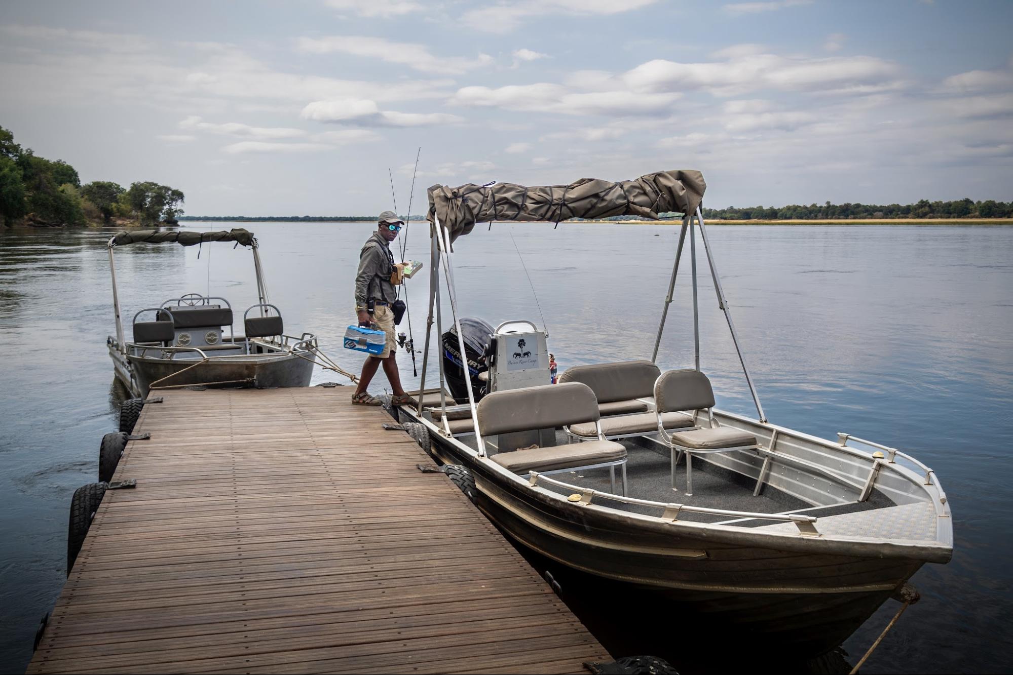 Guide walking the jetty to the Baines River Camp fishing boats on the Zambezi