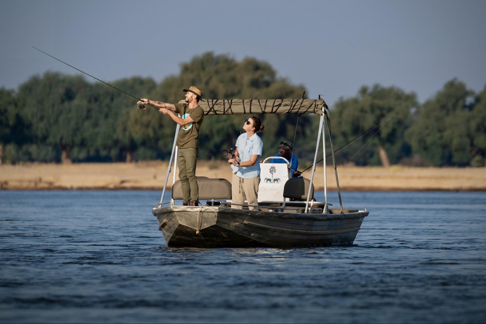 Guests tiger fishing from a boat on the Zambezi River